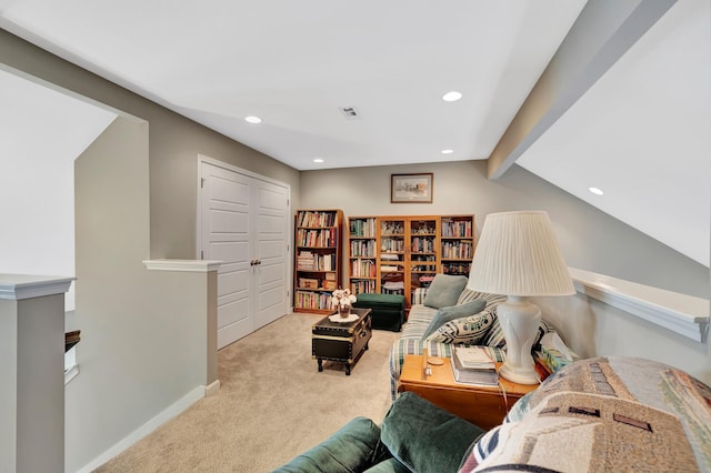 sitting room with recessed lighting, light colored carpet, baseboards, and beam ceiling