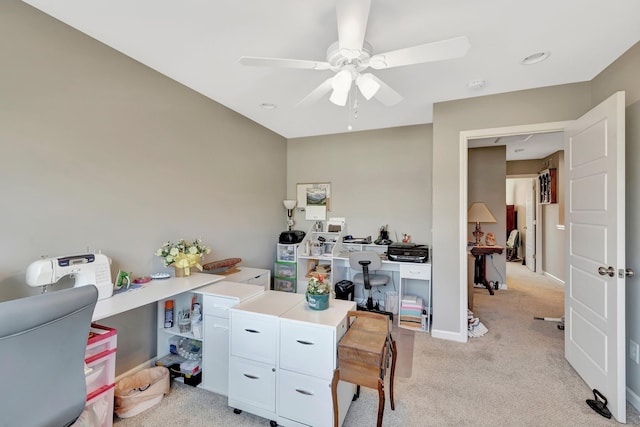 office area with light carpet, baseboards, and a ceiling fan