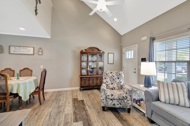 living room with baseboards, ceiling fan, recessed lighting, wood finished floors, and high vaulted ceiling