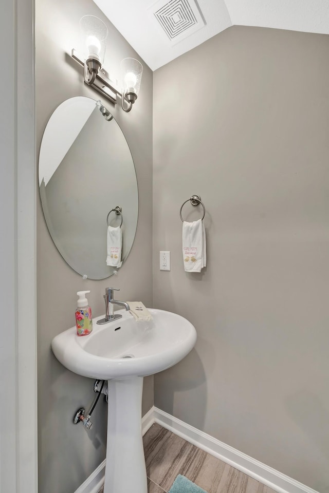 bathroom featuring visible vents, baseboards, and wood finished floors