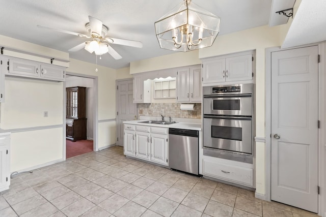 3720 Priest Lake Dr, Nashville, TN 37217 - kitchen with appliances with stainless steel finishes, light countertops, backsplash, ceiling fan with notable chandelier, and a sink