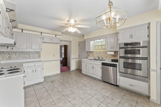 3720 Priest Lake Dr, Nashville, TN 37217 - kitchen featuring stainless steel appliances, decorative backsplash, light countertops, and a sink