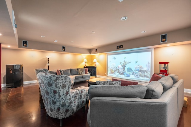 living room featuring baseboards, recessed lighting, and finished concrete floors