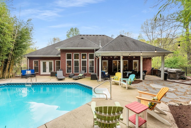 back of property with a patio, fence, brick siding, a jacuzzi, and french doors