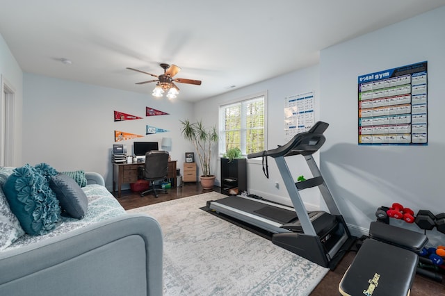 exercise room featuring baseboards and a ceiling fan