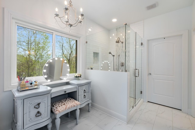 bathroom featuring an inviting chandelier, vanity, marble finish floor, a stall shower, and baseboards