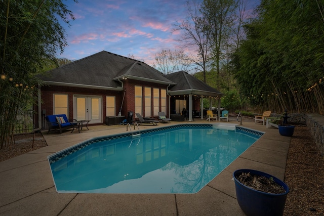 view of pool with a patio area, a gazebo, fence, french doors, and a fenced in pool