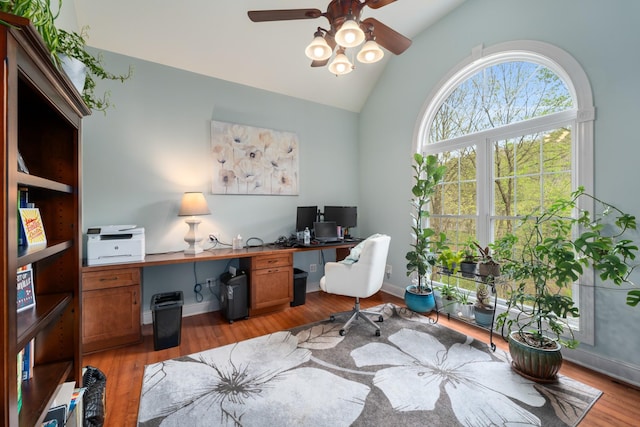 office space with high vaulted ceiling, light wood-style floors, baseboards, and ceiling fan
