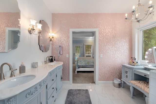 ensuite bathroom featuring a sink, baseboards, an inviting chandelier, and wallpapered walls