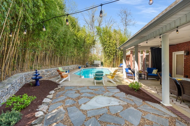 pool with a patio and fence