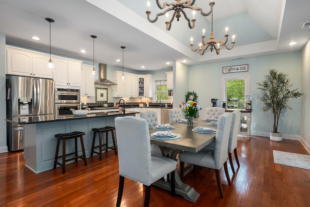 dining space with dark wood-style flooring, a notable chandelier, and plenty of natural light