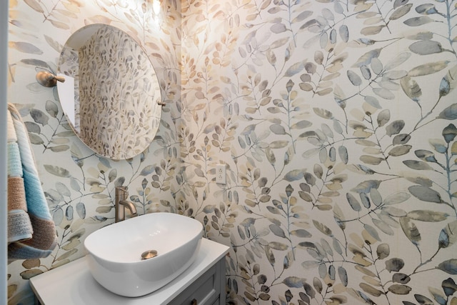 bathroom featuring vanity and wallpapered walls