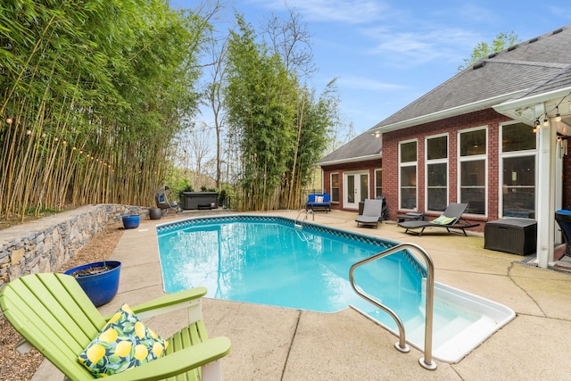 view of pool with a patio, french doors, and a fenced in pool