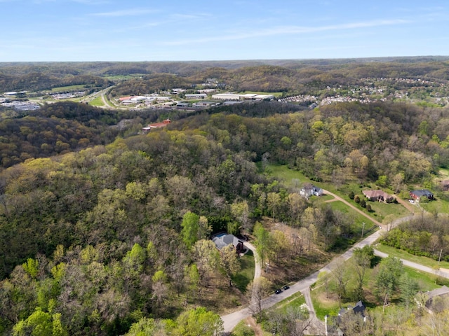 drone / aerial view with a wooded view