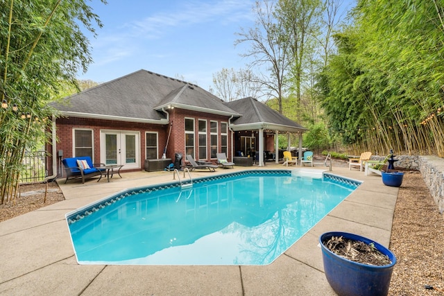 view of pool featuring a patio area, french doors, fence, and a fenced in pool