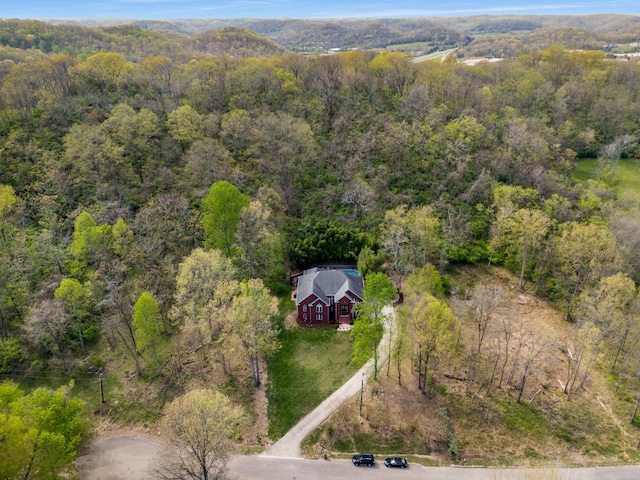 birds eye view of property with a forest view