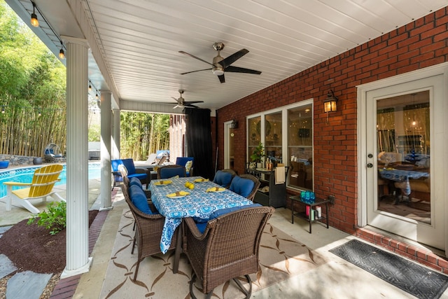 view of patio with an outdoor pool, ceiling fan, and outdoor dining area