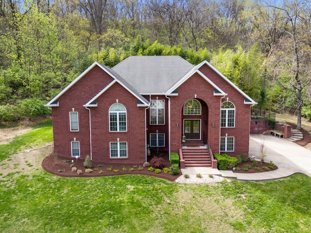 view of front of property featuring brick siding and a front lawn