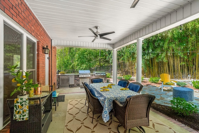 view of patio / terrace with a grill, fence, a ceiling fan, outdoor dining space, and area for grilling