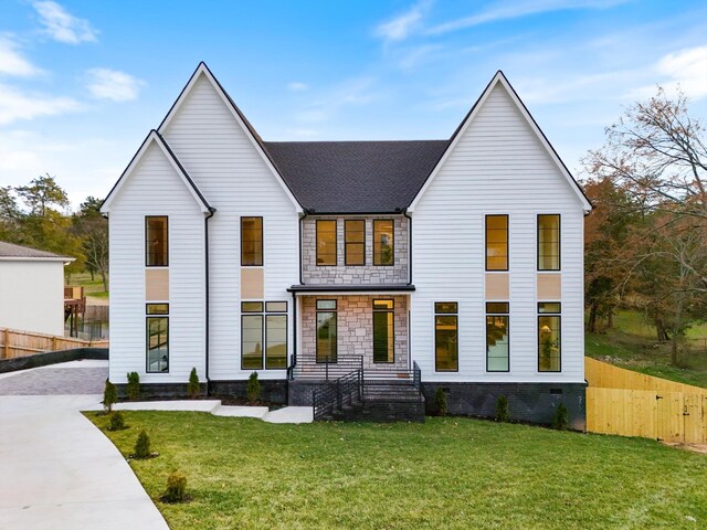 819 Davidson Dr, Nashville, TN 37205 - view of front facade featuring driveway, stone siding, fence, and a front lawn