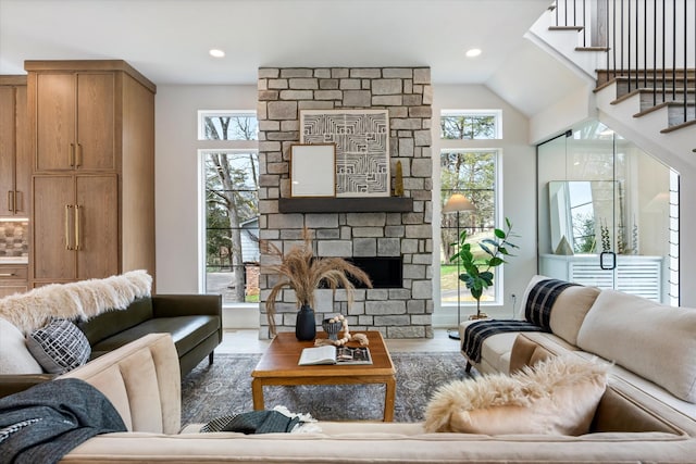 819 Davidson Dr, Nashville, TN 37205 - living room featuring a healthy amount of sunlight, wood finished floors, a stone fireplace, and stairs