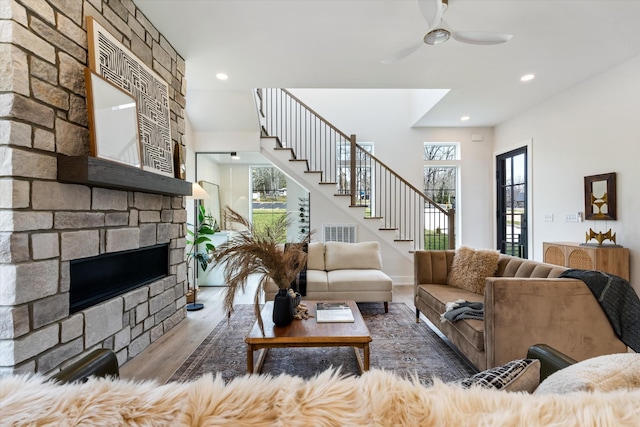 819 Davidson Dr, Nashville, TN 37205 - living area featuring a fireplace, stairs, visible vents, ceiling fan, and wood finished floors
