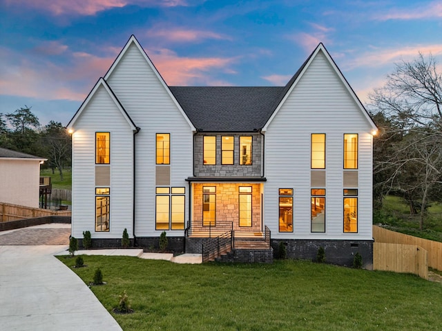 819 Davidson Dr, Nashville, TN 37205 - back of house at dusk featuring a yard, driveway, and fence