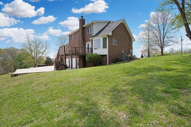 1719 Wynnewood Dr, Chapmansboro, TN 37035 - rear view of house with a chimney, central AC unit, a yard, a wooden deck, and brick siding