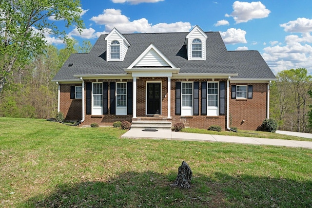 1719 Wynnewood Dr, Chapmansboro, TN 37035 - cape cod house with brick siding, roof with shingles, and a front yard