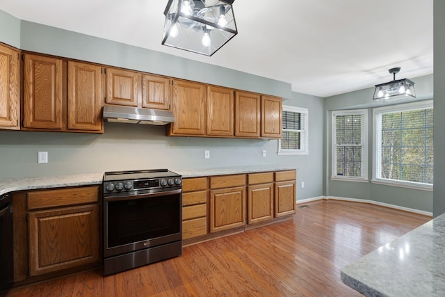 1719 Wynnewood Dr, Chapmansboro, TN 37035 - kitchen with a notable chandelier, light wood-style floors, brown cabinets, stainless steel range with electric stovetop, and under cabinet range hood