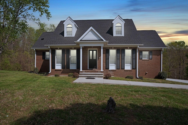 1719 Wynnewood Dr, Chapmansboro, TN 37035 - cape cod house featuring brick siding, a shingled roof, and a front lawn