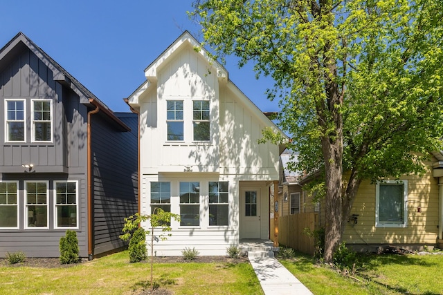 view of front of property featuring board and batten siding and a front lawn