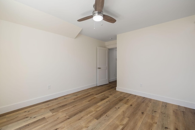 unfurnished room with light wood finished floors, baseboards, and a ceiling fan
