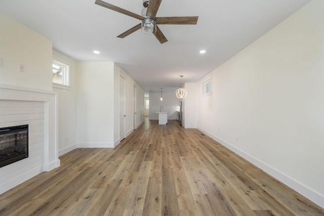 unfurnished living room featuring light wood-type flooring, a ceiling fan, visible vents, recessed lighting, and baseboards