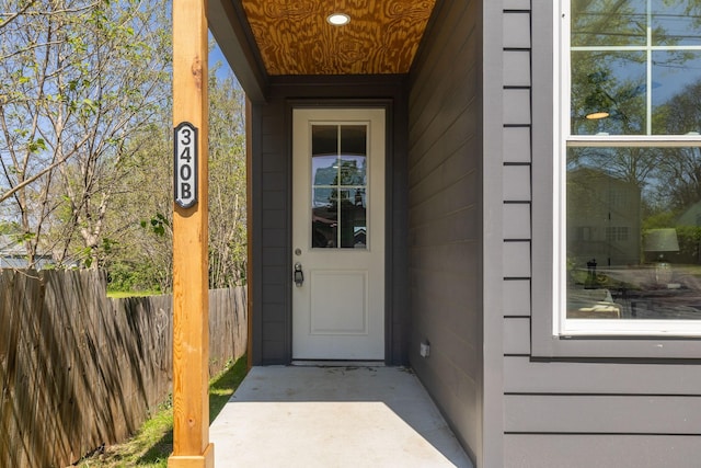 view of exterior entry with fence