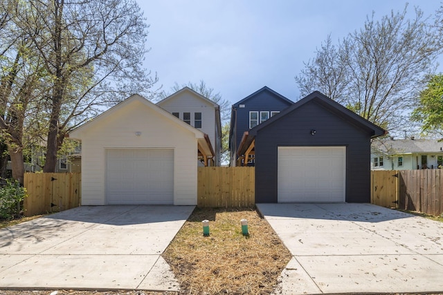 ranch-style home featuring fence, a garage, and driveway