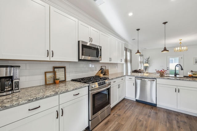 kitchen featuring a sink, tasteful backsplash, appliances with stainless steel finishes, and white cabinetry