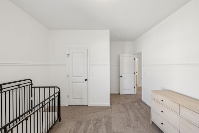 unfurnished bedroom featuring carpet flooring and baseboards