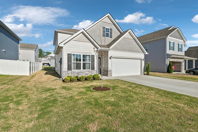craftsman-style house featuring a front yard, driveway, stone siding, and fence