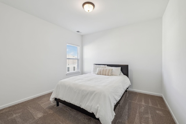 carpeted bedroom with visible vents and baseboards
