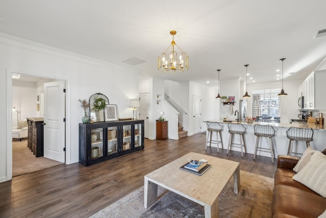 living room with crown molding, dark wood-style flooring, and visible vents