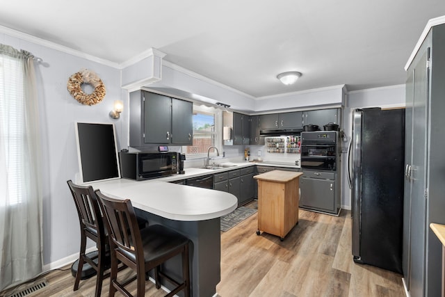 5007 Bonnalynn Dr, Hermitage, TN 37076 - kitchen featuring a peninsula, light countertops, black appliances, visible vents, and a sink
