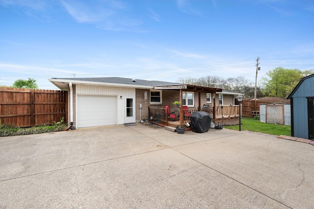 5007 Bonnalynn Dr, Hermitage, TN 37076 - exterior space with a garage, fence, concrete driveway, brick siding, and a wooden deck