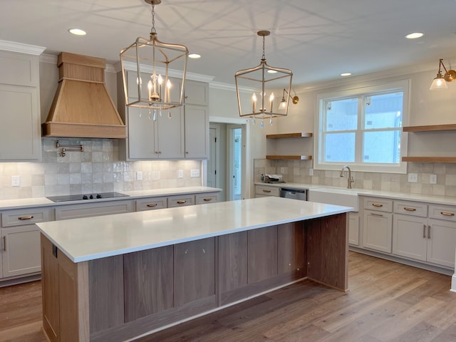 kitchen featuring open shelves, premium range hood, an inviting chandelier, and black electric stovetop