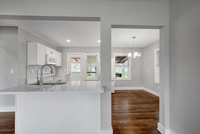 701 Santa Fe Pike, Columbia, TN 38401 - kitchen featuring white appliances, dark wood-type flooring, light countertops, a sink, and baseboards