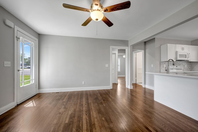 701 Santa Fe Pike, Columbia, TN 38401 - unfurnished living room with dark wood-type flooring, visible vents, baseboards, and ceiling fan