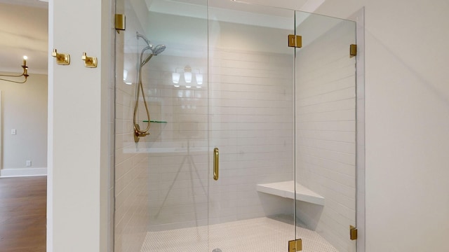 full bathroom with a stall shower and wood finished floors