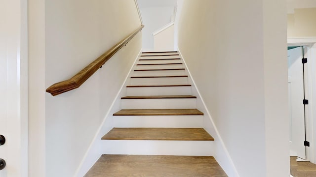 stairway with wood finished floors