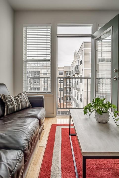 living area with plenty of natural light and wood finished floors