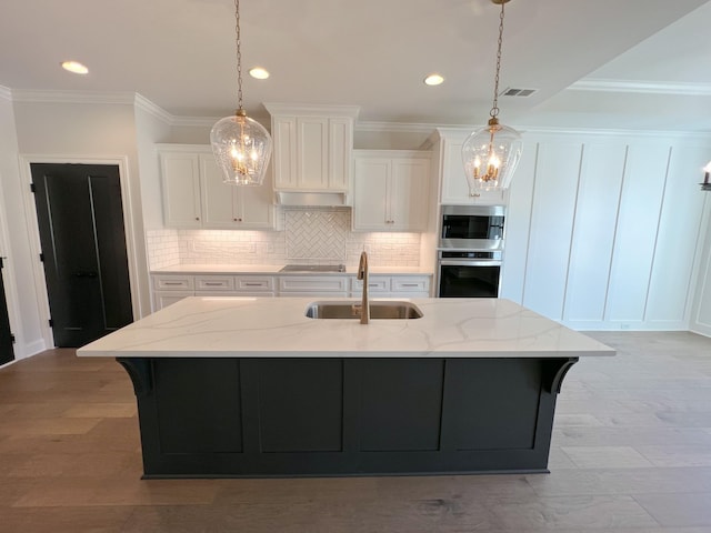 kitchen with an inviting chandelier, recessed lighting, visible vents, appliances with stainless steel finishes, and a sink